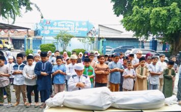 Suasana peserta Darul Arqam SD Muhammadiyah 15 Surabaya (SDM Limas) saat simulasi praktik shalat jenazah di halaman sekolah. (Ali/KLIKMU.CO)